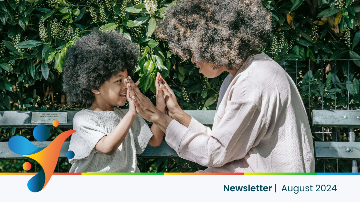 A joyful woman playing with her child outdoors, representing parental burnout self-care and the importance of balancing parenting with well-being.